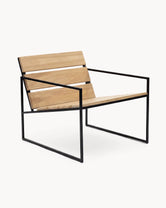 Outdoor lounge chair Arvid by Crea, black powder-coated steel frame with solid teak seat and back, three-quarter view