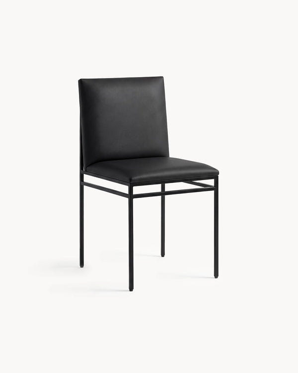 Dining Chair Bella by Crea in jade black vegan leather on a black powder-coated steel frame, three-quarter view
