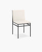 Bella dining chair in sand leather with black frame, showcasing modern elegance and sophistication.