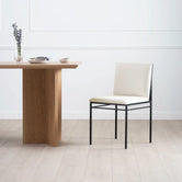 Dining chair Bella features a black frame and ivory leather cushion, perfect for a modern dining space.