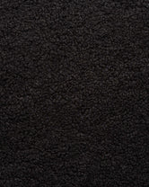Close-up of black boucle, showing the looped texture of the woven pile