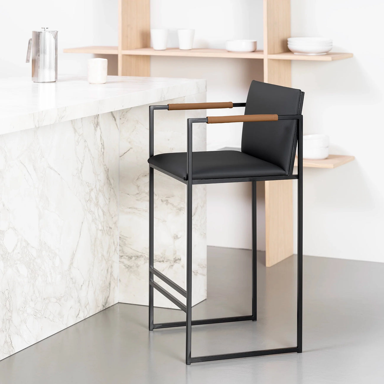 Bruno bar stool in jade black leather with coffee bean armrests, perfect for kitchen islands and bar counters.