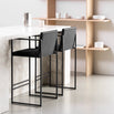 Bruno bar stools in black velvet at a modern kitchen island, showcasing Scandinavian design and sleek armrests.