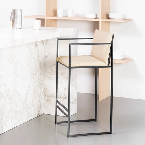 Bruno bar stool in black with sand leather upholstery, featuring armrests and Nordic design, perfect for kitchen islands.