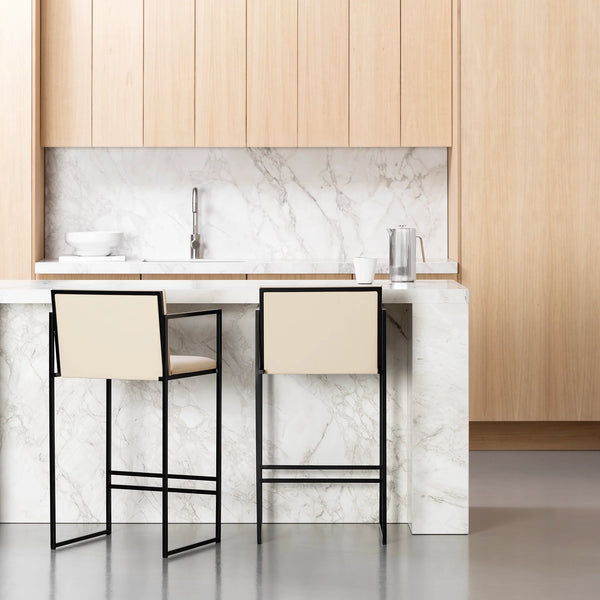 Bruno bar stool in black and sand leather, featuring armrests, perfect for modern kitchen islands and open-plan dining.