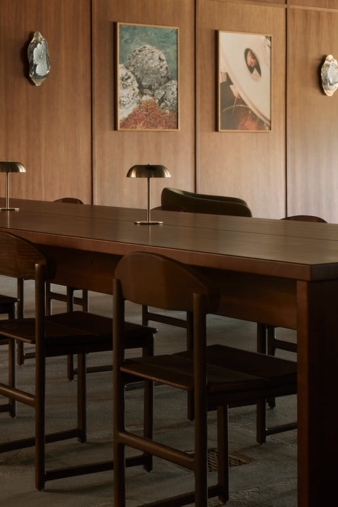 Custom dark wood Karin chairs from by Crea arranged around a communal table inside Norrbottens Destilleri.
