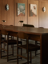 Custom dark wood Karin chairs from by Crea arranged around a communal table inside Norrbottens Destilleri.