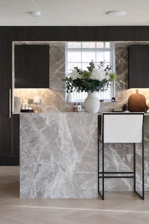Bar Stool Philip in ivory bouclé at a kitchen island in a styled interior