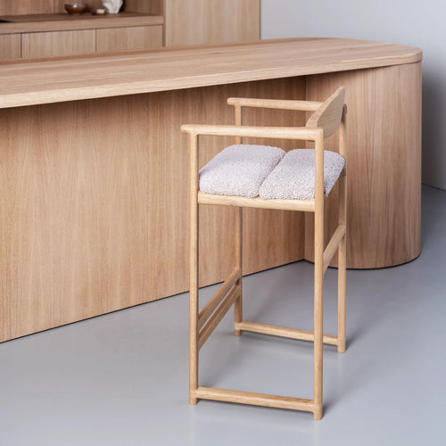 Carl bar stool in oak with greige bouclé upholstery, featuring clean lines for stylish seating.