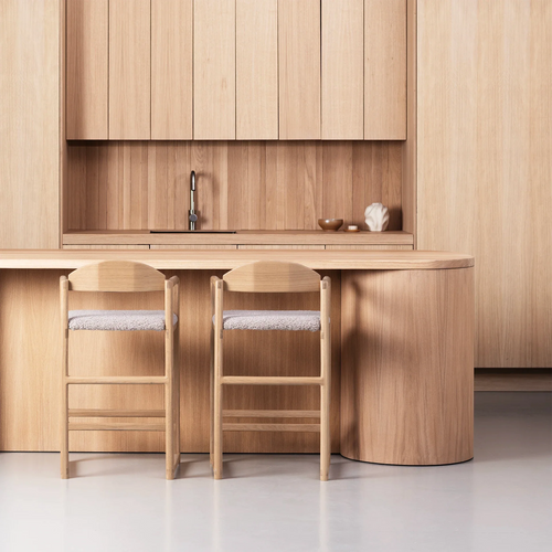 Carl bar stool in oak with greige bouclé, paired with a modern wooden kitchen, offering stylish seating.