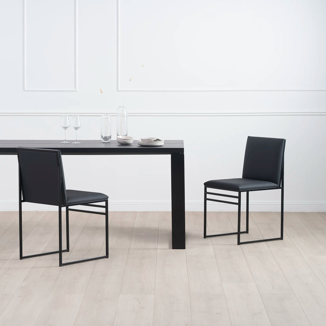 Diana dining table in black with black oak, accompanied by sleek black chairs—ideal for modern dining spaces.