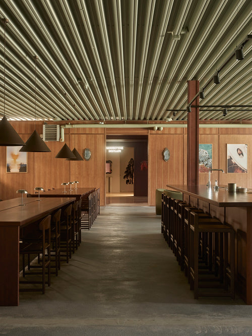 Wide interior view of Norrbottens Destilleri with Ebba bar stools and Karin chairs from by Crea arranged around the bar and communal tables.