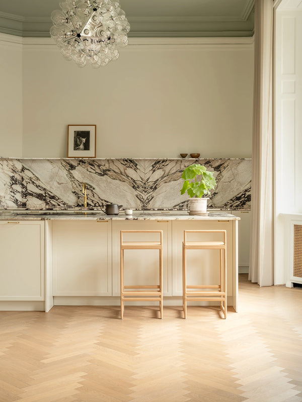 Ebba bar stools in solid oak at a kitchen island in a Copenhagen apartment
