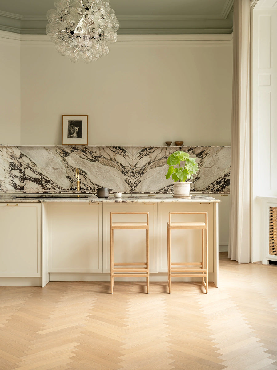Ebba bar stools in solid oak at a kitchen island in a Copenhagen apartment