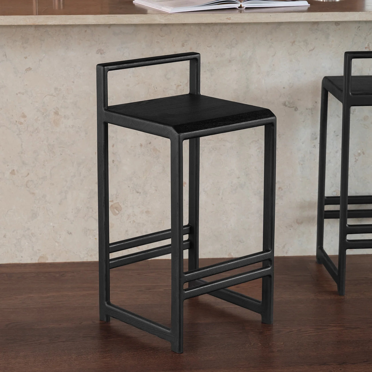 Ebba Bar stool in black oak, featuring a modern design that enhances any kitchen or bar space.