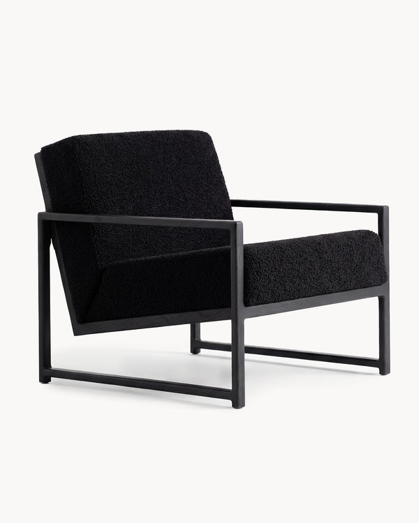 Armchair Einar in black bouclé on a solid black oak frame, three-quarter view