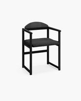 Dining chair Erik in black oak wood frame with black bouclé cushion for a refined dining experience.