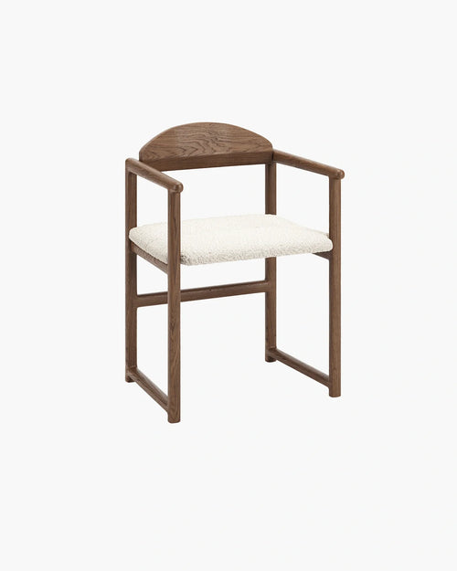 Erik dining chair in dark oak with ivory bouclé, showcasing a modern and stylish design.
