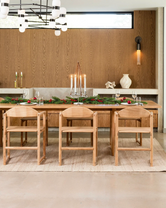 Scandinavian Christmas dining setup with by Crea Erik Dining Chairs in oak, styled with greenery, candles, and festive tableware.
