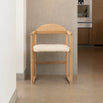 Erik dining chair in oak with ivory bouclé, featuring a warm wood frame and soft seating for relaxed dining.