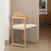 Erik dining chair in oak with ivory bouclé, showcasing warm wood and soft texture for relaxed dining.