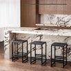 Eva Bar stools in black oak at a modern kitchen island with marble countertop, showcasing clean lines and a slim profile.