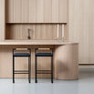 Freja bar stools with black leather seats and frame in a modern kitchen setting with wooden interiors.