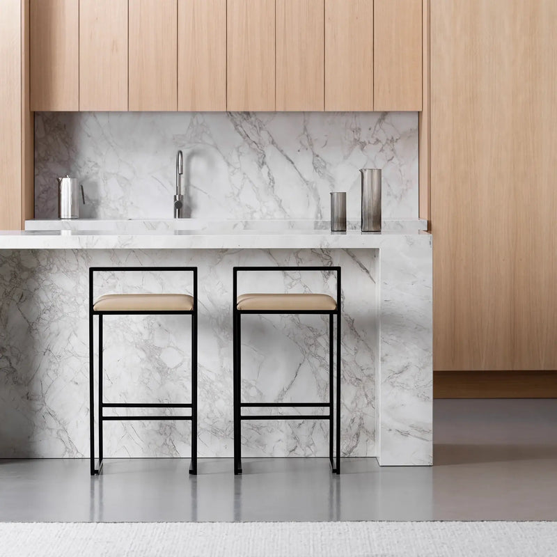 Freja bar stool in black steel with latte leather seat, perfect for modern kitchen islands and bar counters.