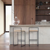 Freja bar stools with black steel frame and latte leather seats in modern kitchen setting.
