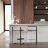 Leather Bar Stool Freja with black frame and latte leather cushion in a modern kitchen setting.