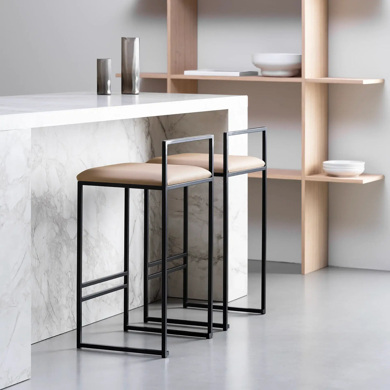 Freja bar stools in black steel with latte leather seats, perfect for modern kitchen islands or bar counters.