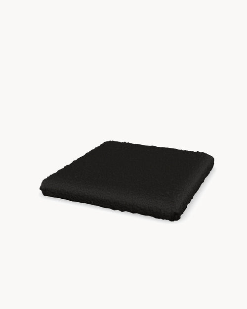 Cushion for the Freja bar stool in Black bouclé, three-quarter view
