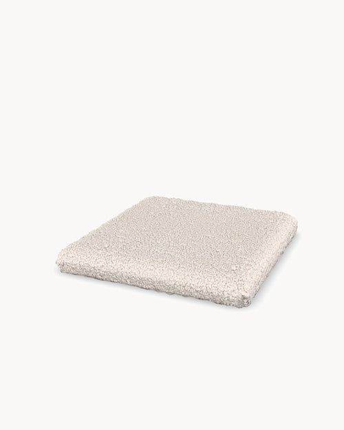 Cushion for the Freja bar stool in Ivory bouclé, three-quarter view