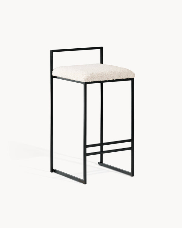 Breakfast Bar Stool Freja by Crea with black frame and ivory bouclé cushion for modern kitchen decor.