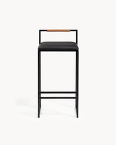 Bar Stool Freja with black frame, black leather cushion, and brown backrest for modern interior decor.
