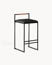 Bar Stool Freja with black frame, black leather cushion, and brown backrest for kitchen interiors.