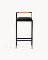 Bar Stool Freja with black frame, black velvet cushion, and coffee bean backrest for kitchen interiors.