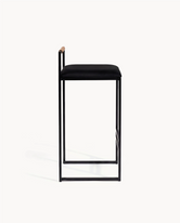 Bar Stool Freja in black frame with black velvet cushion and coffee bean backrest, perfect for kitchen islands.