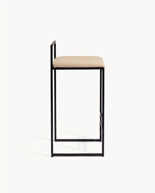 Side view of Freja Leather Bar Stool with black frame and latte leather cushion.