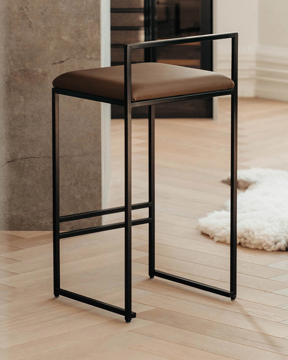 Bar Stool Freja in chocolate vegan leather on a black steel frame
