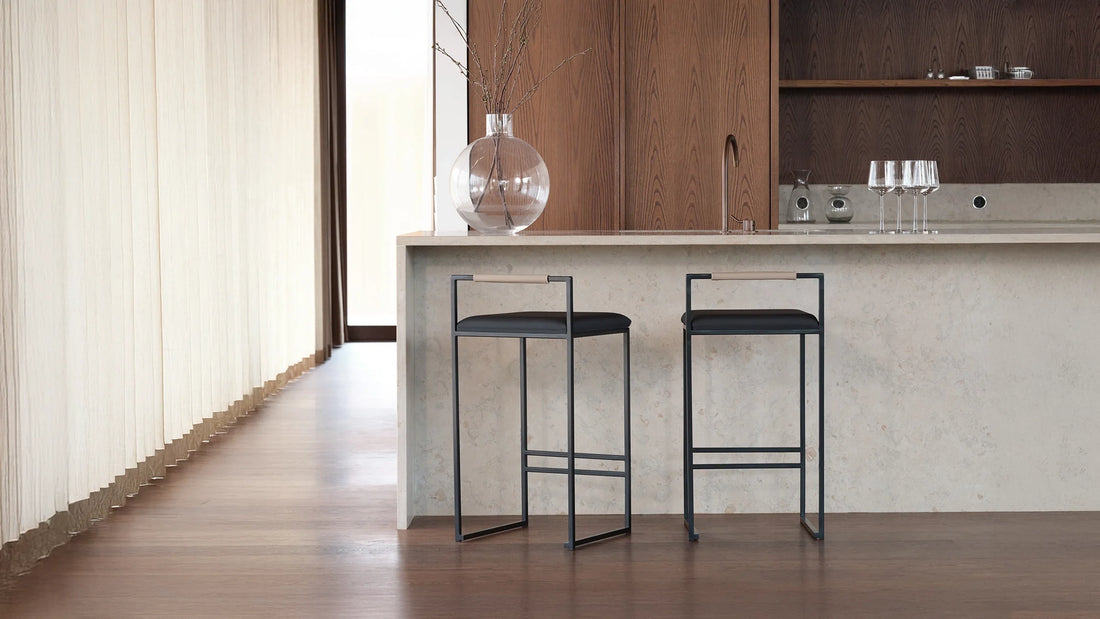 Two Freja bar stools at a concrete kitchen island