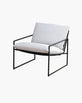 Kenny lounge chair in black frame with white cushions, combining modern design and comfort for any space.