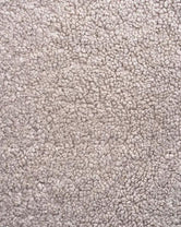 Close-up of greige boucle, showing the looped texture of the woven pile