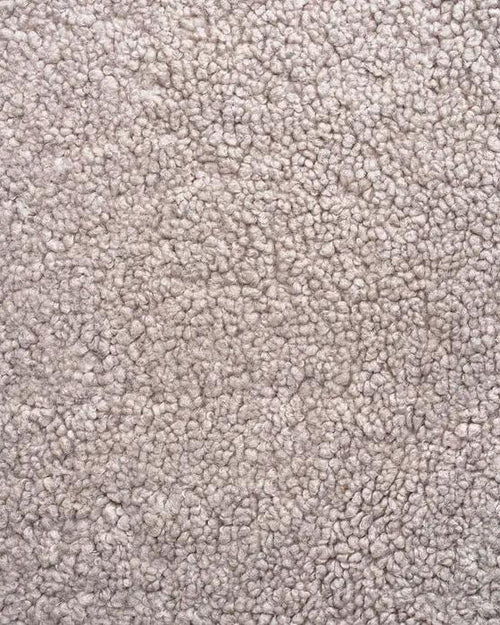 Close-up of greige boucle, showing the looped texture of the woven pile