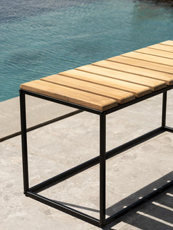 Close-up of the stainless steel frame on the Hedvig garden bench, poolside