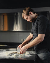 Roland, owner and restaurant chef at Hotel Milla Montis in South Tyrol, preparing fresh dough by hand in the hotel kitchen.