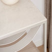 Close-up of the Iris bed table featuring a beige lunar dekton top and sleek frame, ideal for modern bedroom decor.