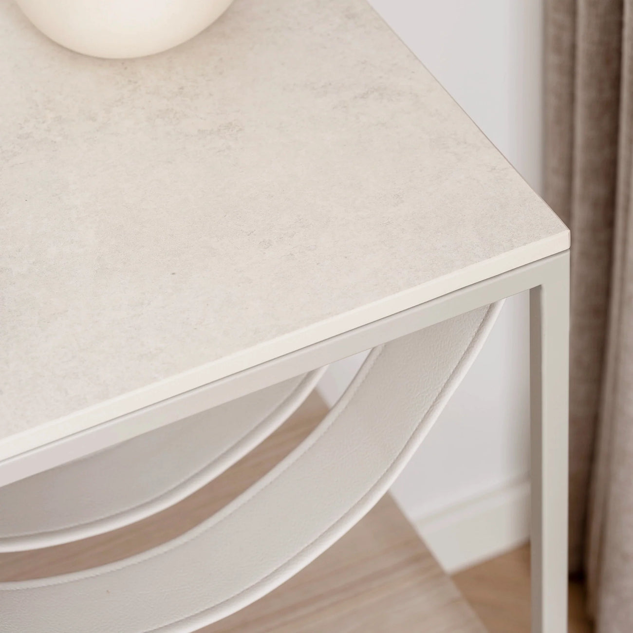 Close-up of the Iris bed table featuring a beige lunar dekton top and sleek frame, ideal for modern bedroom decor.