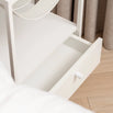 Iris bed table in white featuring a minimalist design and open drawer, perfect for modern bedroom interiors.