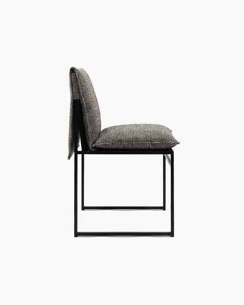 Modern chair with a textured backrest and black metal frame on a white background